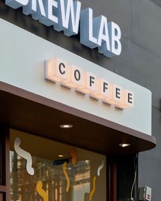 there is a coffee shop front with the words brew lab on it's side