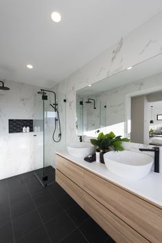 a bathroom with two sinks and a shower