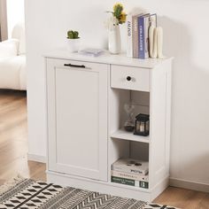 a white cabinet sitting on top of a hard wood floor