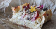 a piece of bread with flowers on it sitting on top of wax paper covered in wax paper