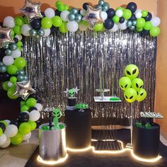 an alien themed birthday party with balloons and streamers