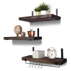 two wooden shelves with metal brackets and hooks on each shelf, one holding an alarm clock