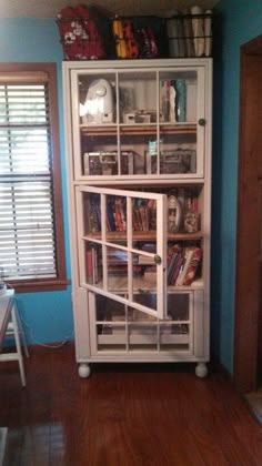 a white book case sitting in the corner of a room