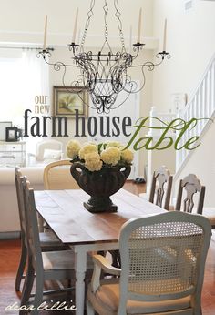 a dining room table with chairs and a chandelier hanging from it's ceiling