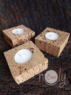 three small candles sitting on top of wooden blocks