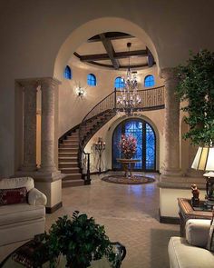 a living room filled with furniture and a chandelier