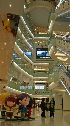 people are walking through the mall with their luggage