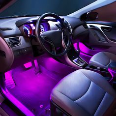 the interior of a car with purple lights