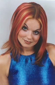 a woman with red hair and blue dress