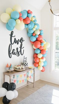 a party with balloons and decorations on the wall