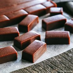 some chocolate pieces are sitting on a piece of paper