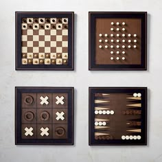 four pieces of wood are arranged on a wall with chess board and checkers in the middle