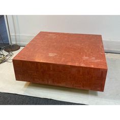 a wooden table sitting on top of a carpeted floor