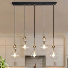 an image of a kitchen with light bulbs hanging from it's ceiling and counter top