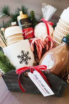 a basket filled with hot chocolates, marshmallows and candy canes