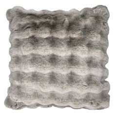 a gray and white pillow with wavy fur on the front, it's made out of