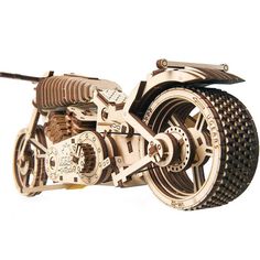 a wooden model of a motorcycle with gears and wheels on the front wheel is shown