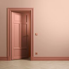 an open door in a pink room with parquet flooring