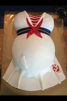 a cake shaped like a sailor's outfit on top of a table