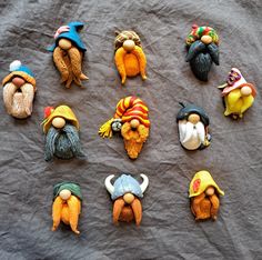 seven gnomes with different hats and beards on a gray cloth covered tablecloth