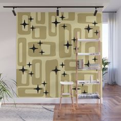 an abstract wallpaper design with black stars and circles on yellow background in a living room