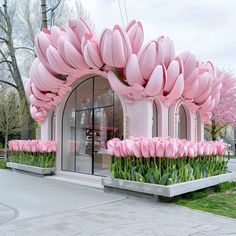 a building with pink flowers in front of it