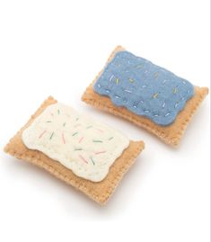 two small pieces of felt with sprinkles on them sitting next to each other