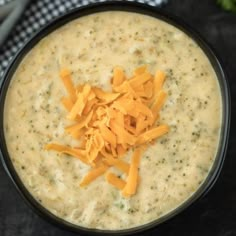 a bowl filled with cheese on top of a table