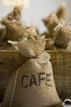 burlap bag with the word cafe written on it sitting in front of other burlap bags