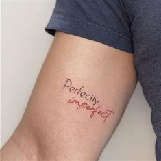 a woman's arm with the word perfectly imperfect written on it, and an arrow in red ink