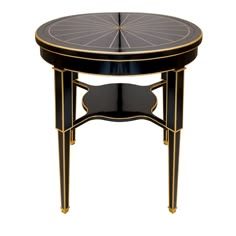 a black and gold side table with an intricate design on the top, against a white background