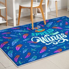 a blue area rug with the words bread and wings on it in front of some chairs