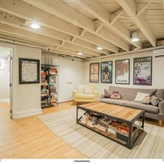 a living room filled with furniture and pictures on the wall