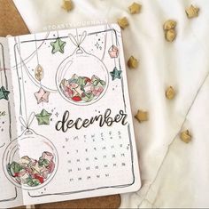 a calendar with christmas decorations on it and the words december written in gold stars next to it