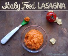 baby food lasagna in a glass bowl next to an apple, spoon and tomato