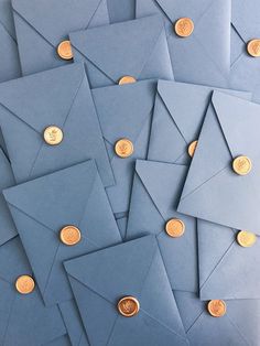 many blue envelopes with gold coins on them