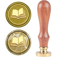 a stamp with a book on it and a wax seal in the shape of a book