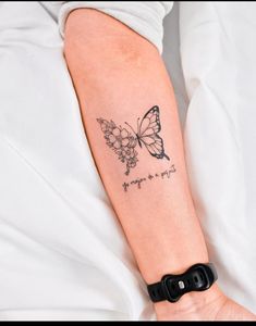 a woman's arm with a butterfly tattoo on the left side of her arm