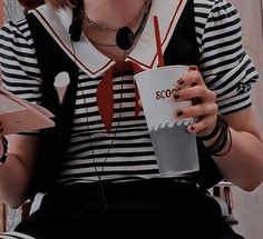 a woman sitting down holding a coffee cup