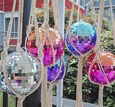 several disco ball ornaments hanging from a pole