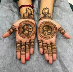 two hands with henna designs on them