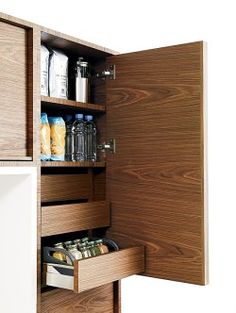 an open cabinet door with food and drinks in it