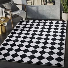 a black and white checkered rug in the middle of a room with a chair