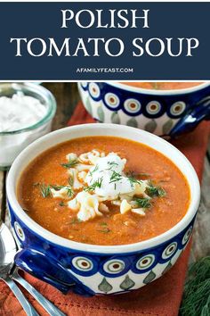 two bowls filled with tomato soup and topped with sour cream