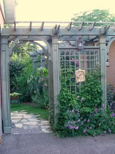 an outdoor garden with lots of plants and flowers on the side of the building,