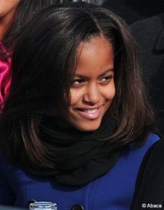 a smiling young woman sitting at a table