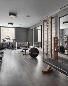 the gym is clean and ready for people to use it as an exercise center in this modern apartment