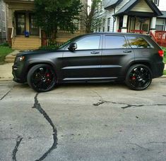 a black jeep parked in front of a house