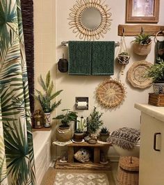 a bathroom with plants and towels hanging on the wall