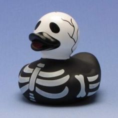 a black and white skeleton rubber ducky on a blue background with its mouth open